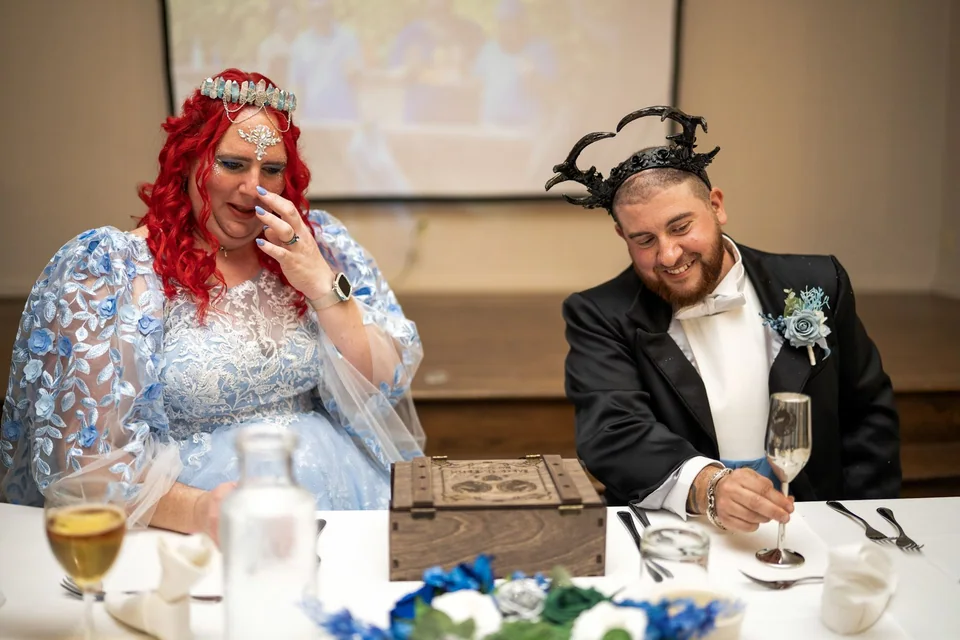 Newlyweds laughing together during their reception