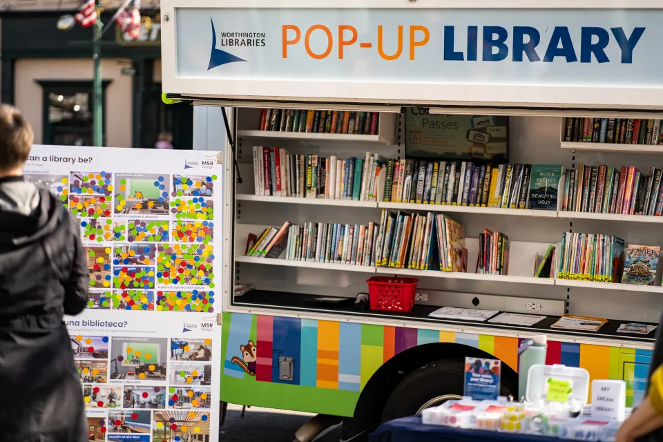 Books arranged on the shelves of a pop-up library cart