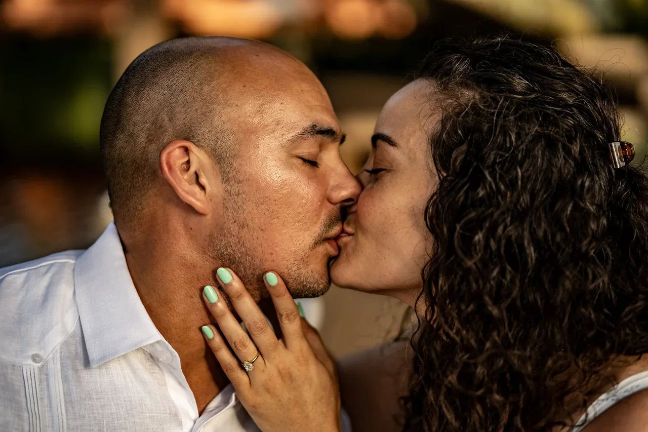 Couple kissing in a close-up outdoor portrait