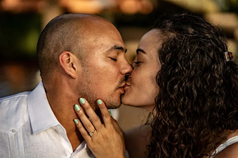 Couple kissing in a close-up outdoor portrait