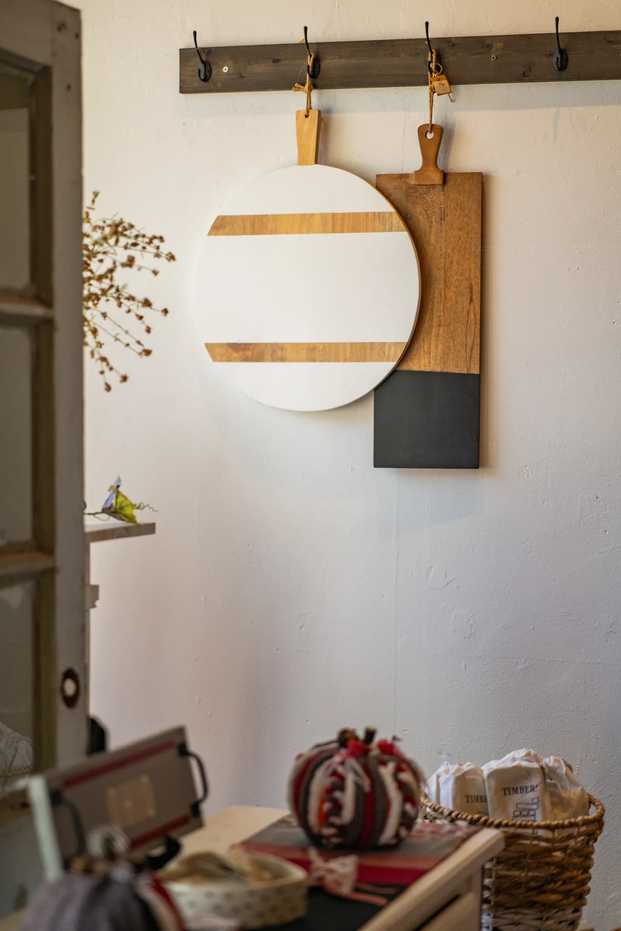 Wooden cutting boards displayed on a light interior wall