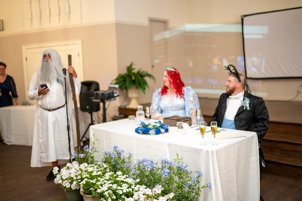 A candid wedding toast drawing laughter from the couple