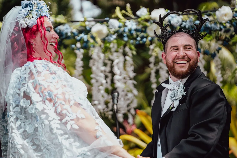 Newlyweds laughing together during their outdoor ceremony