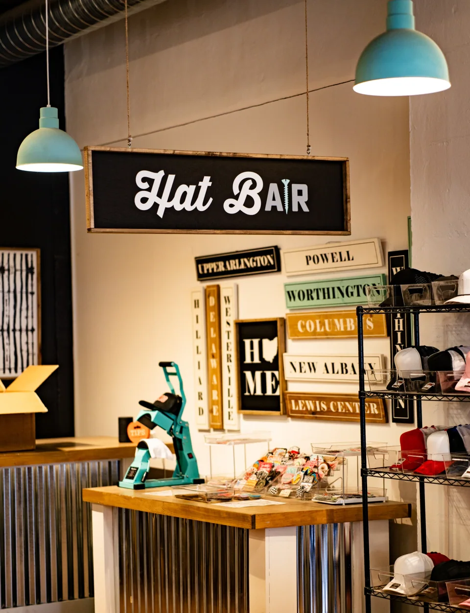 A hat bar and workshop counter beneath hanging lights