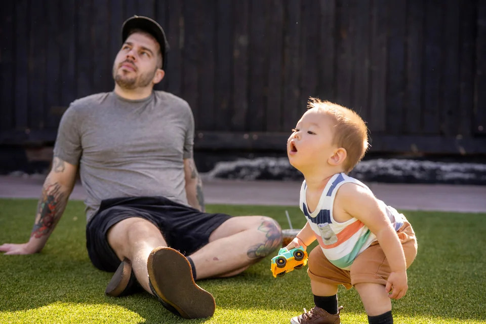 Uncle and young nephew reacting to something overhead during a portrait session